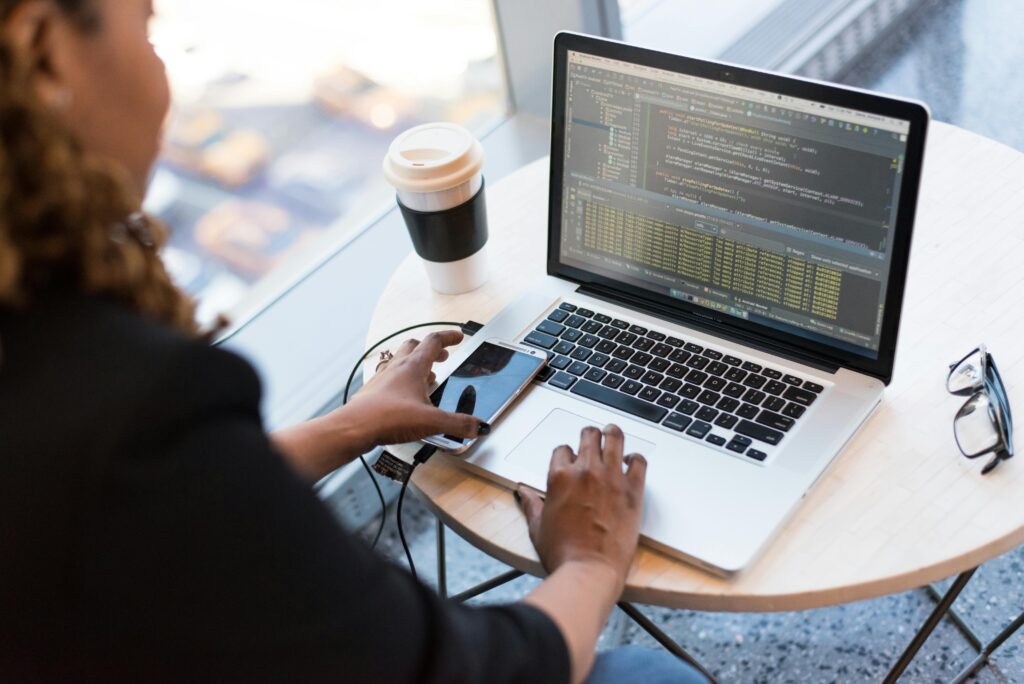 firewalls vs antiviruses: woman coding on computer