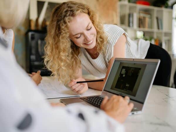 importance of backing up your data - woman smiling at laptop